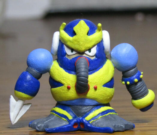 a small painted clay figure of waveman in a chibi style